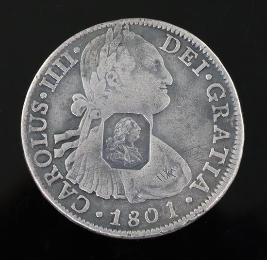 A rare George III octagonal countermarked silver dollar, crisp countermark on a fairly worn 8 Reales coin.